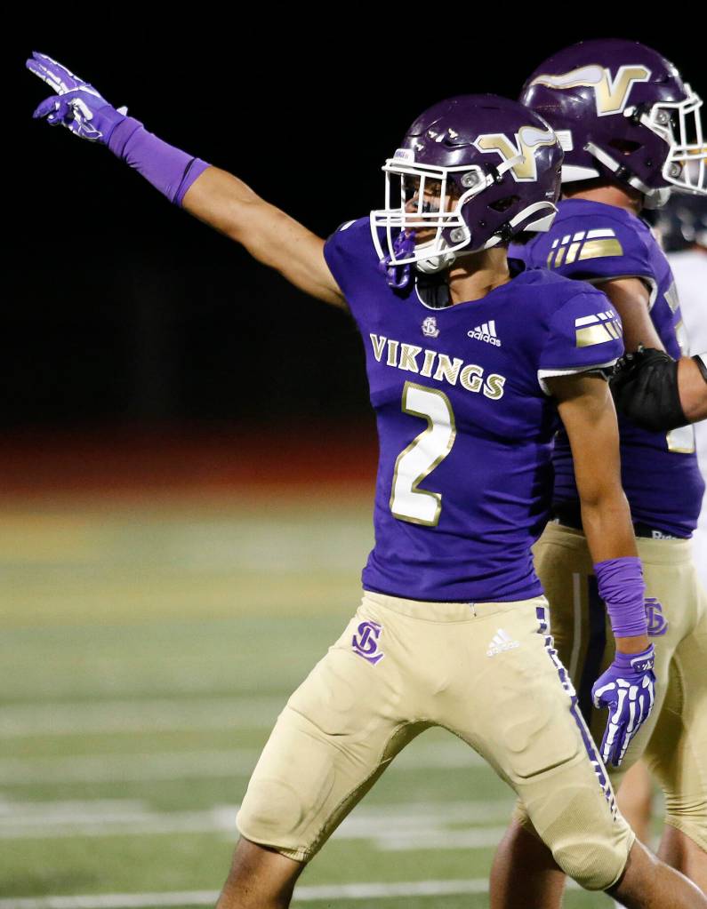 Lake Stevens Steven Lee Jr. signals a change of possession after his defense stopped Bellevue on 4th down Friday, Sep. 9, 2022, at Lake Stevens High School in Lake Stevens, Washington. (Ryan Berry / The Herald)