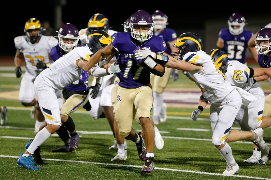 Lake Stevens Jayden Limar muscles through the defense against Bellevue on Friday, Sep. 9, 2022, at Lake Stevens High School in Lake Stevens, Washington. (Ryan Berry / The Herald)