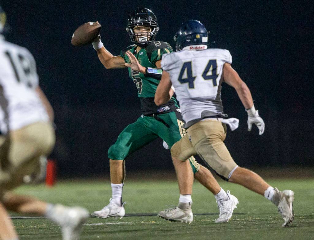 Marysville Getchells Carter Schmidt throws the ball during the game Arlington on Friday, Sept. 9, 2022 in Marysville, Washington. (Olivia Vanni / The Herald)