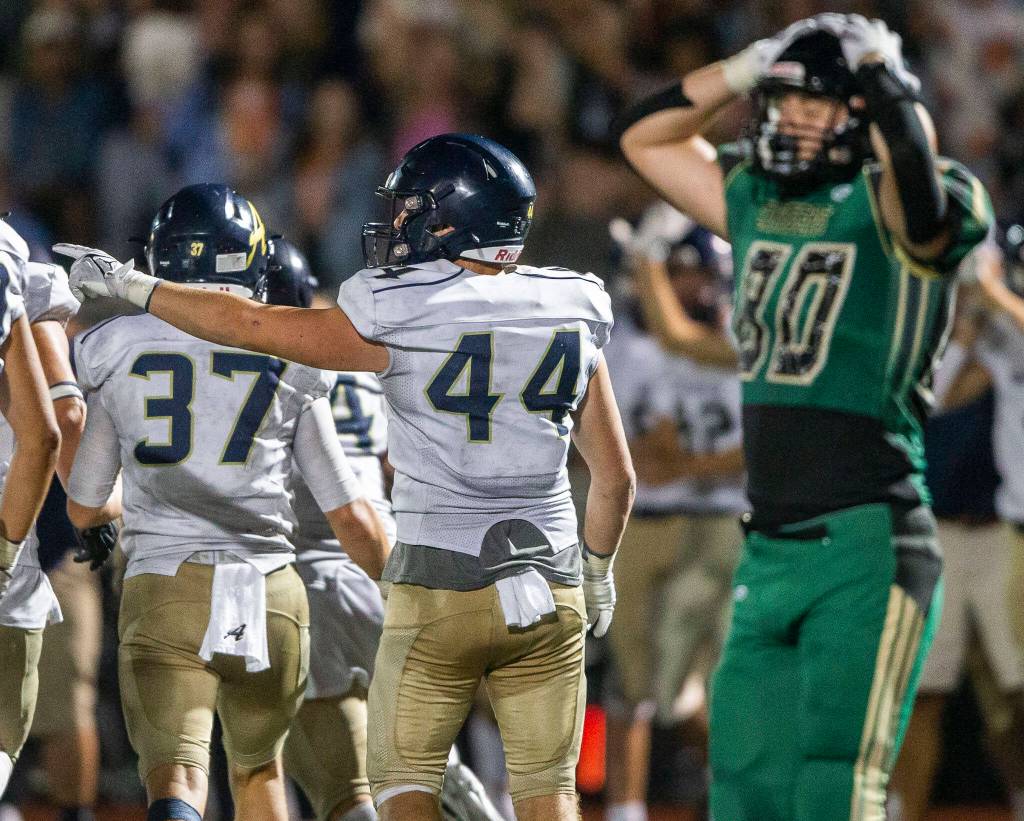 Arlingtons Spencer Fischer points to signal Arlington ball after a turnover during the game against Marysville Getchell on Friday, Sept. 9, 2022 in Marysville, Washington. (Olivia Vanni / The Herald)