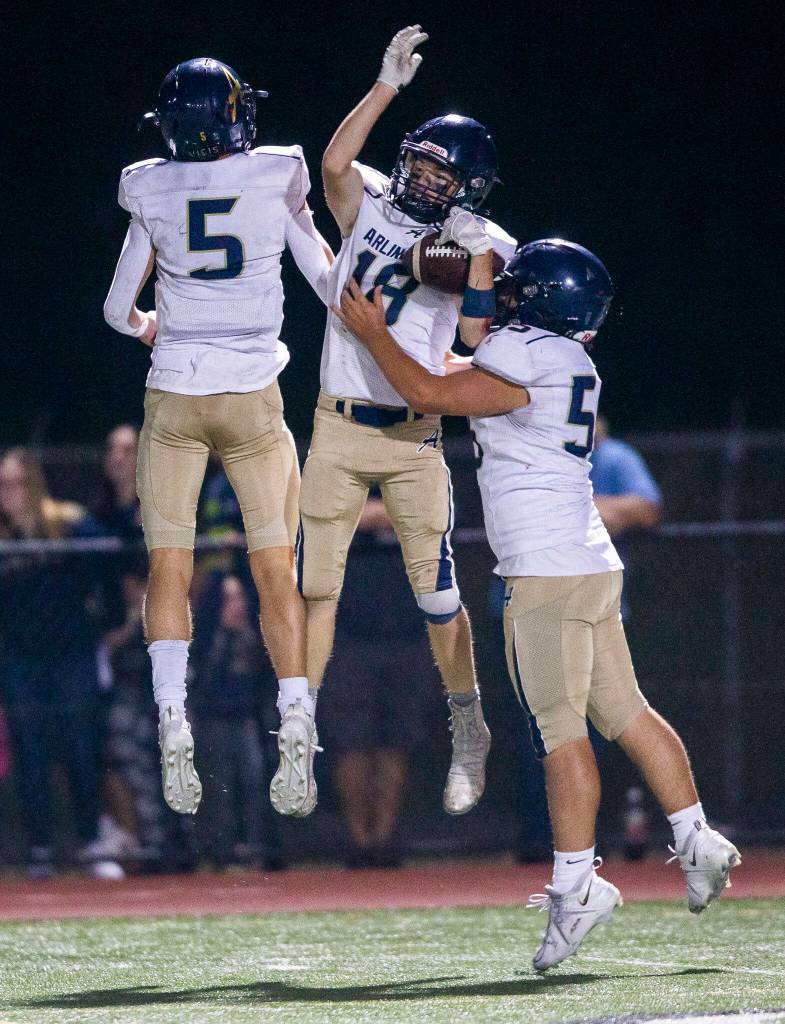 Arlingtons Neil Carroll celebrates his touchdown during the game against Marysville Getchell on Friday, Sept. 9, 2022 in Marysville, Washington. (Olivia Vanni / The Herald)