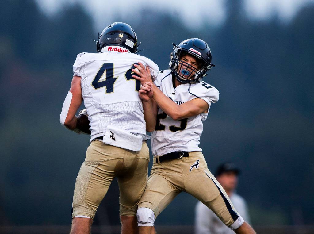 Arlingtons Spencer Fischer celebrates a touchdown with teammate Chase Deberryduring the game against Marysville Getchell on Friday, Sept. 9, 2022 in Marysville, Washington. (Olivia Vanni / The Herald)