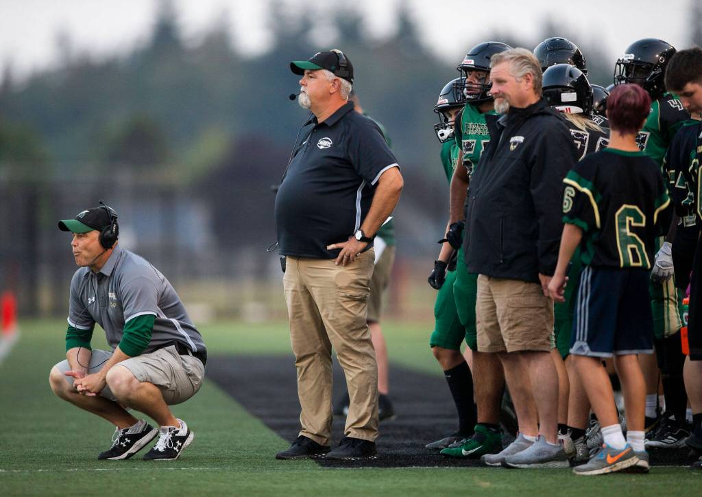 Marysville Getchell coaches grimaces after a touchdown by Arlington during the game on Friday, Sept. 9, 2022 in Marysville, Washington. (Olivia Vanni / The Herald)