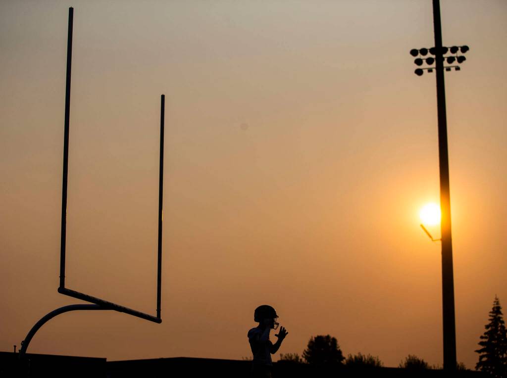 Arlington players warm up before the game against Marysville Getchell on Friday, Sept. 9, 2022 in Marysville, Washington. (Olivia Vanni / The Herald)