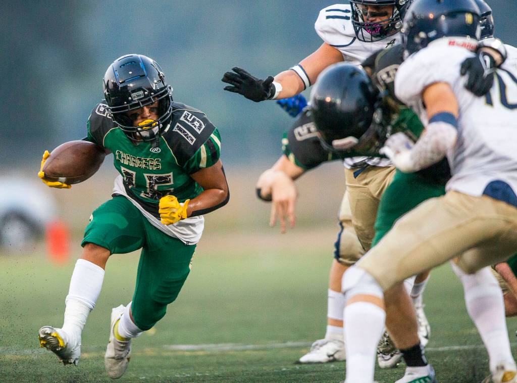 Marysville Getchells Dylan Padilla looks for an opening to run through during the game Arlington on Friday, Sept. 9, 2022 in Marysville, Washington. (Olivia Vanni / The Herald)