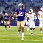 Washington running back Wayne Taulapapa runs for a touchdown during the first quarter of a game against Kent State on Sept. 3, 2022, in Seattle. (Dean Rutz/The Seattle Times via AP)
