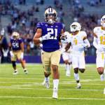 Washington running back Wayne Taulapapa heads for a touchdown against Kent State during the first quarter of an NCAA college football game Saturday, Sept. 3, 2022, in Seattle. (Dean Rutz/The Seattle Times via AP)