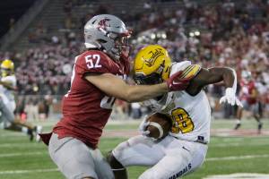 Washington State linebacker Kyle Thornton, left, tackles Idaho running back Anthony Woods during the second half of an NCAA college football game Saturday, Sept. 3, 2022, in Pullman, Wash. Washington State won 24-17. (AP Photo/Young Kwak)