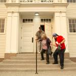 Trevor Meakin helps his mother Robyn and father Al down the steps of the Startup Event Center before making their way to Monroe in search for a hotel for them and there three cats after being displaced from their Baring home by the Bolt Creek Fire on Saturday, Sep. 10, 2022, in Startup, Washington. (Ryan Berry / The Herald)
