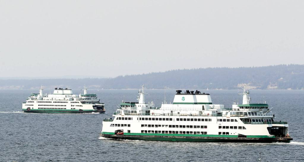 Ferries cross path in the waters of Possession Sound through the smoke and haze of the Darrington wildfires in Mukilteo, Washington on September 9, 2022. (Kevin Clark / The Herald)