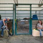 Doneatta Godinez and Nikki Prather, both of Gold Bar, take care of their horses at a stable on Sunday, Sep. 11, 2022, at the Evergreen State Fairgrounds in Monroe, Washington. Godinez brought 10 of her horses to the emergency stables at the fairgrounds in response to the Bolt Creek Fire, and Prather brought two. Both still have animals back on their properties near the site of the fire and are prepared to evacuate them as well if the flames moves closer. (Ryan Berry / The Herald)