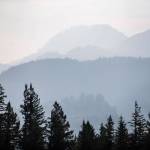 Smoke from the Bolt Creek fire silhouettes mountain ridge and tree layers just outside of Index on Monday. (Olivia Vanni / The Herald)