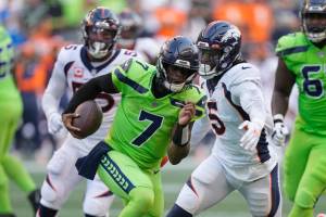 Seattle Seahawks quarterback Geno Smith (7) scrambles against the Denver Broncos during the first half of an NFL football game, Monday, Sept. 12, 2022, in Seattle. (AP Photo/Stephen Brashear)