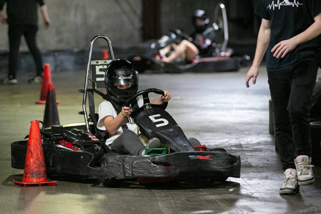 A young driver receives instruction during a training session at Traxx Indoor Raceway. (Ryan Berry / The Herald)