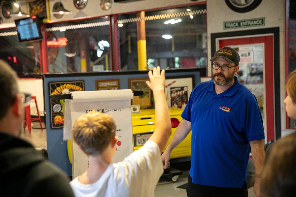 Chris Kruse, manager at Traxx Indoor Raceway, gives a safety rundown before visitors take a driving course. Kruse has been with the company for 23 years, working for the Wanzers since nearly the beginning. (Ryan Berry / The Herald)