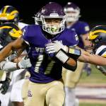 Lake Stevens’ Jayden Limar muscles through the defense against Bellevue on Friday, Sep. 9, 2022, at Lake Stevens High School in Lake Stevens, Washington. (Ryan Berry / The Herald)