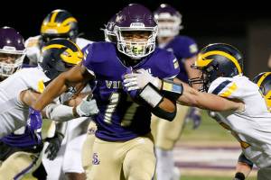 Lake Stevens’ Jayden Limar muscles through the defense against Bellevue on Friday, Sep. 9, 2022, at Lake Stevens High School in Lake Stevens, Washington. (Ryan Berry / The Herald)