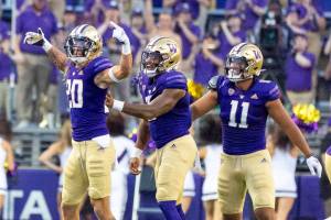 University of Washington's Asa Turner, left, picked off Kent State's first pass, settng up the Huskies first score of the game, Saturday, Sept. 3, 2022. (Dean Rutz/The Seattle Times via AP)/The Seattle Times via AP)