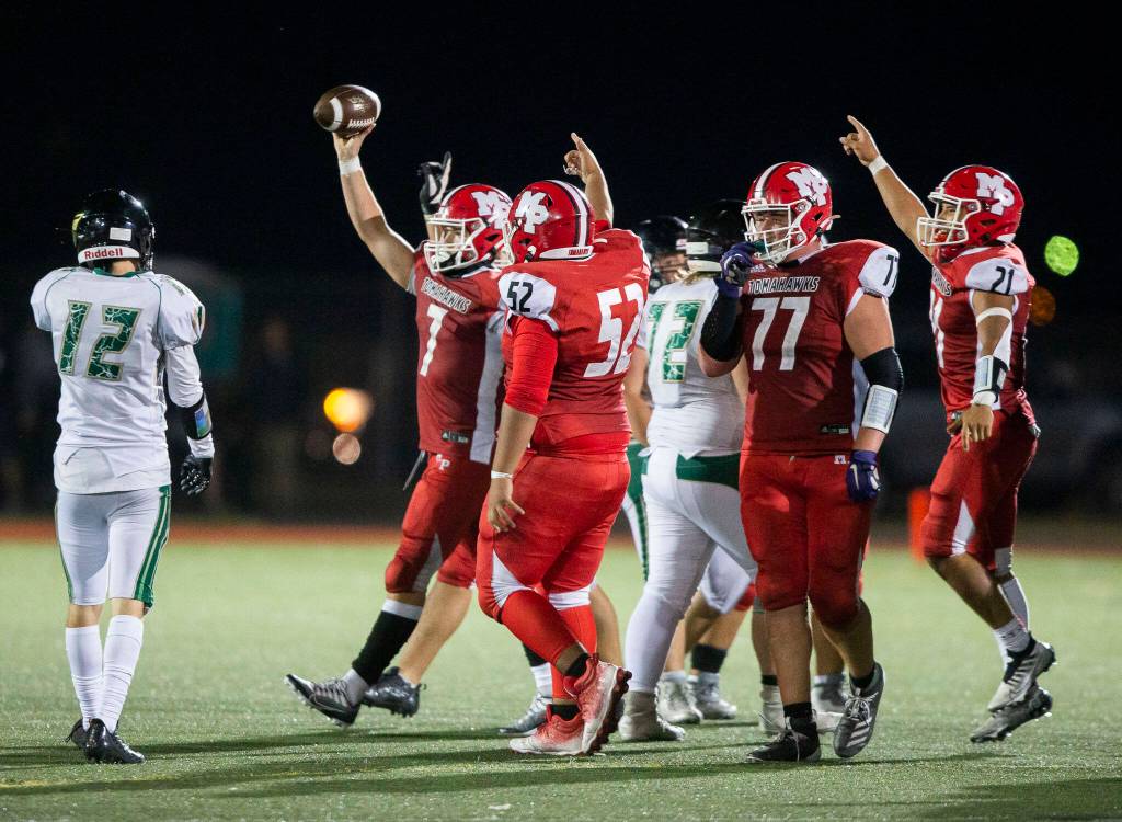Marysville Pilchucks Christian Van Natta lifts the ball in the air to celebrate a turnover during the game against Marysville Getchell on Friday, Sept. 16, 2022 in Marysville, Washington. (Olivia Vanni / The Herald)