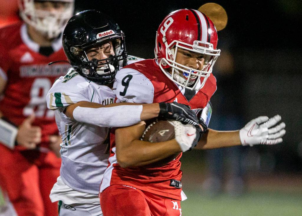 Marysville Pilchucks Benito Mejia is tackled by Marysville Getchells Eric Davydenko during the game on Friday, Sept. 16, 2022 in Marysville, Washington. (Olivia Vanni / The Herald)