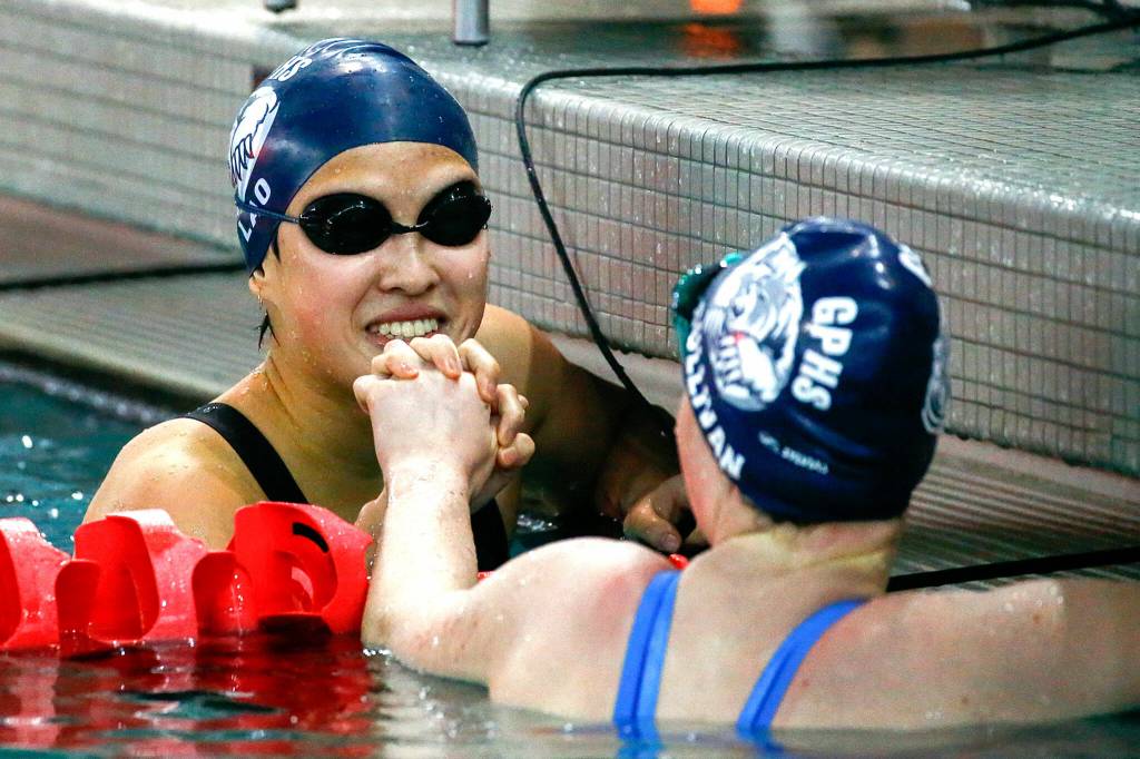 Glacier Peaks Lily Lao, left, and Alexa Sullivan celebrate a one-two finish in the 200-yard freestyle during the Class 4A girls District 1 championships meet at Snohomish Aquatic Center on Nov. 6, 2021. (Kevin Clark / The Herald)
