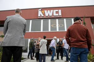 People gather outside of the new Northwest Carpenters Institute building prior to a grand opening celebration Thursday, Sep. 29, 2022, in Burlington, Washington. (Ryan Berry / The Herald)