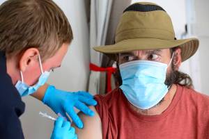 Seth McCoard, of Townshend, Vt., gets a Pfizer COVID-19 booster shot during a vaccine clinic held by Rescue Inc. at Leland & Gray Middle and High School, in Townshend, Vt., on Tuesday, Sept. 20, 2022. (Kristopher Radder/The Brattleboro Reformer via AP)