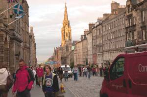 People stroll along Edinburgh’s Royal Mile, one of Europe’s most interesting historic walks, as Edinburgh Castle looms in the distance. (Rick Steves' Europe)