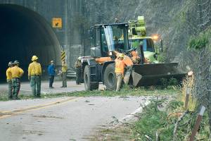 Crews work to clear debris from U.S. 2 on Saturday, Sept. 16, 2022 after the Bolt Creek fire destabilized the steep terrain. (Lauren Bonney, PIO NW team 8)
