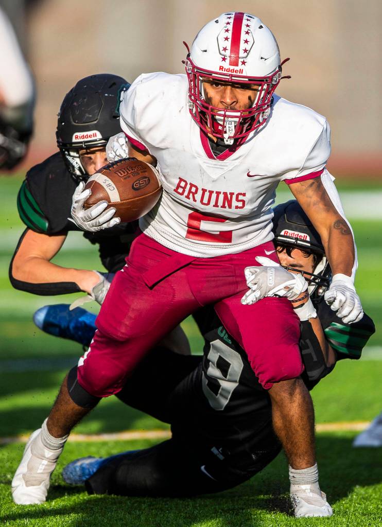 Cascades Julian Thomas runs through a tackle during the game against Jackson on Friday, Sept. 23, 2022 in Everett, Washington. (Olivia Vanni / The Herald)