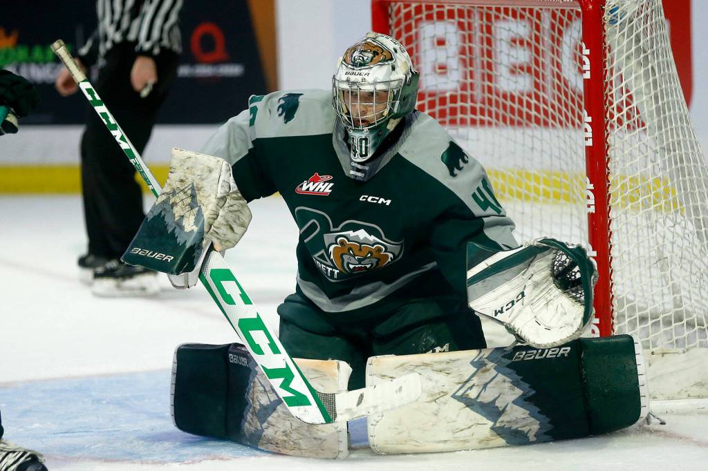 Everett Silvertips goalie Braden Holt goes down into the butterfly while playing during the season opener against the Vancouver Giants on Saturday, Sep. 24, 2022, at Angel of the Winds Arena in Everett, Washington. (Ryan Berry / The Herald)