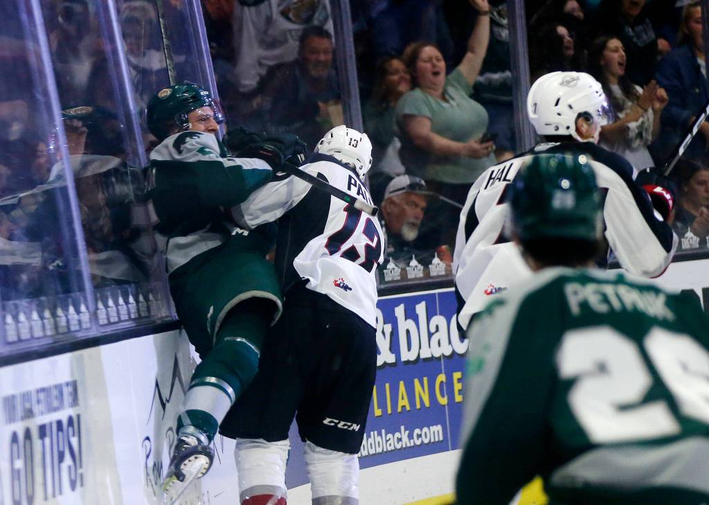Everett Silvertips Eric Jamieson gets slammed into the glass after scoring during the season opener against the Vancouver Giants on Saturday, Sep. 24, 2022, at Angel of the Winds Arena in Everett, Washington. (Ryan Berry / The Herald)