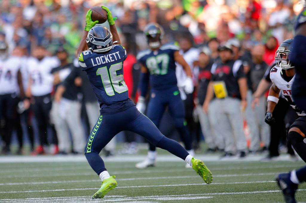 The Seattle Seahawks Tyler Lockett comes down with a reception against the Atlanta Falcons on Sunday, Sep. 25, 2022, at Lumen Field in Seattle, Washington. (Ryan Berry / The Herald)