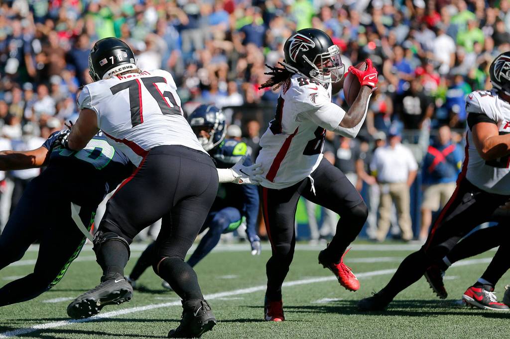 The Atlanta Falcons Cordarrelle Patterson slips a tackle and takes the ball for a long touchdown run against the Seattle Seahawks on Sunday, Sep. 25, 2022, at Lumen Field in Seattle, Washington. (Ryan Berry / The Herald)
