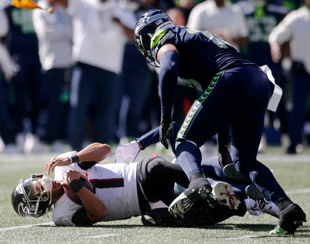 The Atlanta Falcons Marcus Mariota gets taken down for a sack against the Seattle Seahawks on Sunday, Sep. 25, 2022, at Lumen Field in Seattle, Washington. (Ryan Berry / The Herald)