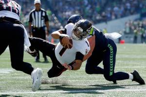 The Atlanta Falcons’ Marcus Mariota keeps the ball and scores Atlanta’s first touchdown of the game against the Seattle Seahawks on Sunday, Sep. 25, 2022, at Lumen Field in Seattle, Washington. (Ryan Berry / The Herald)