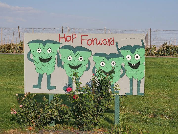 A sign celebrating the hop harvest is seen outside Carpenter Ranches hop farm in Granger. (Photo courtesy of R.J. Whitlow, owner and head brewer at 5 Rights Brewing)