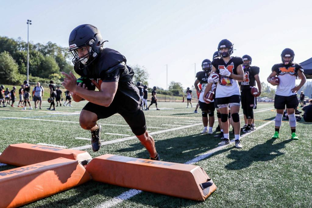 Beau Pruett runs through a drill during practice at Monroe High School on Aug. 30. (Kevin Clark / The Herald)