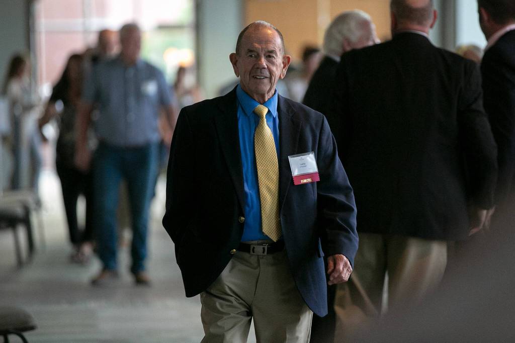Local historian Larry ODonnell arrives to accept a Hall of Fame honor on behalf of the late Enoch Bradshaw, who coached football in Washington 100 years ago, during the 2022 Snohomish County Sports Hall of Fame banquet Wednesday, Sep. 28, 2022, at the Edward D. Hansen Conference Center in Everett, Washington. (Ryan Berry / The Herald)