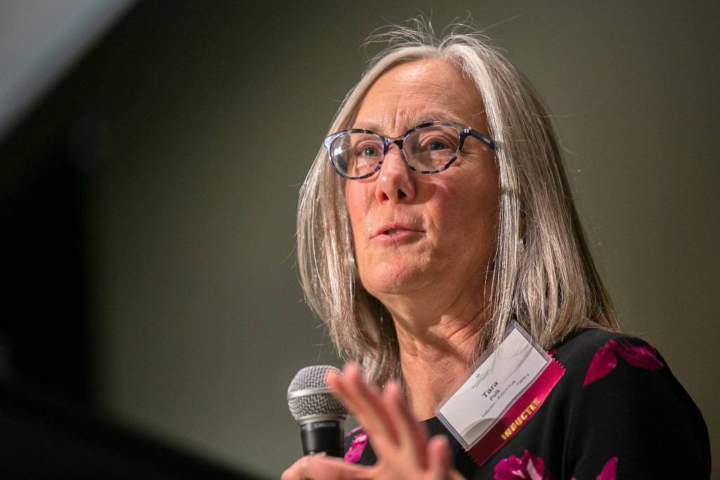 Tara Polk gives a tearful acceptance on behalf of her late husband, athletic director Robert Polk, during the 2022 Snohomish County Sports Hall of Fame banquet Wednesday, Sep. 28, 2022, at the Edward D. Hansen Conference Center in Everett, Washington. (Ryan Berry / The Herald)