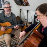 Phil Spirito and Libby Reed play a song together in their home on Sunday, Oct. 9, 2022 in Monroe, Washington. (Olivia Vanni / The Herald)