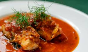 Cody Castiglia makes a dish of black cod and red sauce. Photographed in Snohomish, Washington on April 27, 2022.  (Kevin Clark / The Herald)