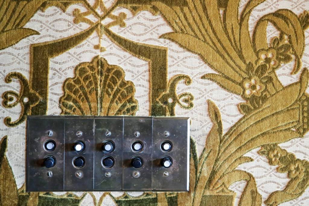 Push button light switch surrounded by velvet wall coverings at the Rucker Mansion on Oct. 11 in Everett. (Kevin Clark / The Herald)