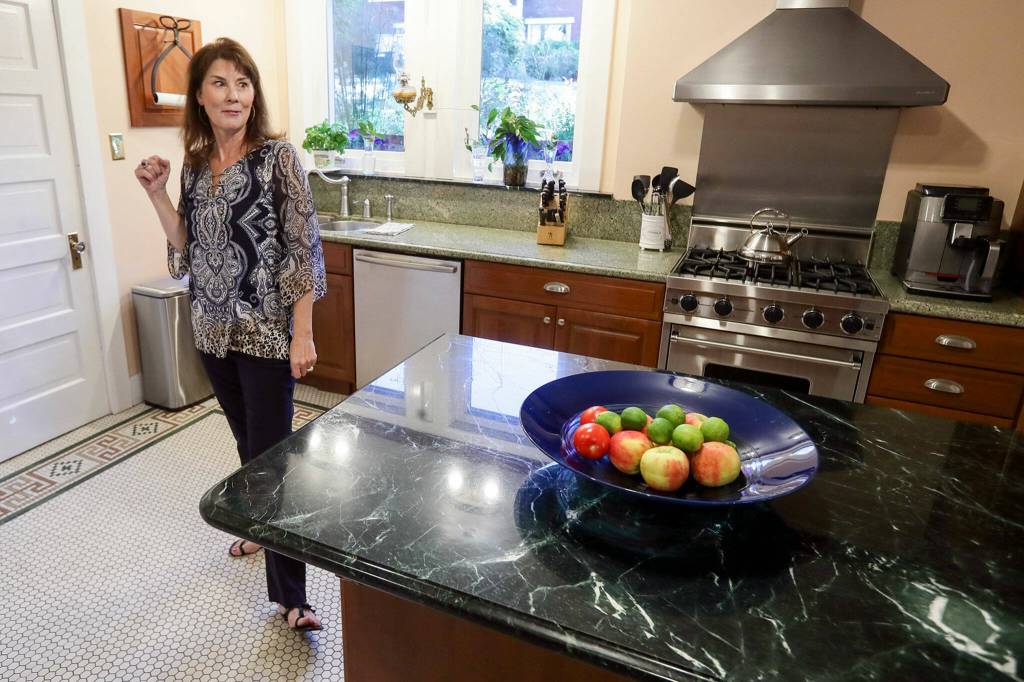 Brenda Kerr in caterer kitchen at her home, the Rucker Mansion on Oct. 11 in Everett. (Kevin Clark / The Herald)