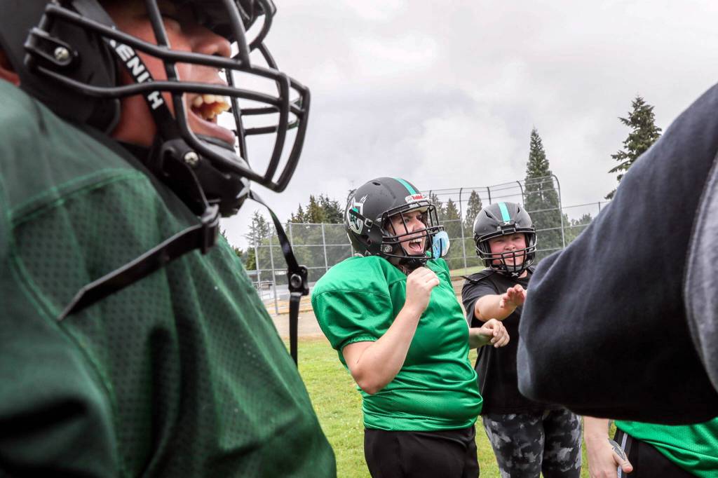 Ines Cuevas, left to right, Emily Ketzenberg and Meghan share a laugh during practice on Sept. 3, in Shoreline. (Kevin Clark / The Herald)