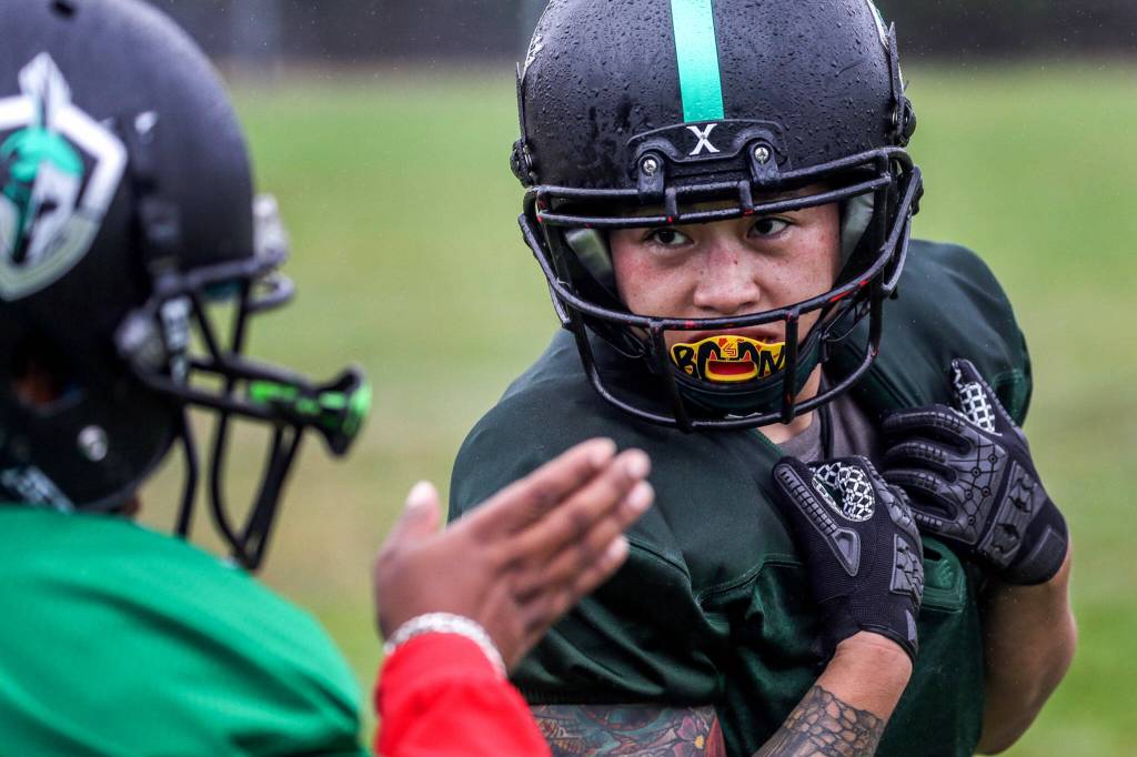 Yolly Delgado, right, get route help from Phaedra Keaton during practice on Sept. 3, in Shoreline. (Kevin Clark / The Herald)