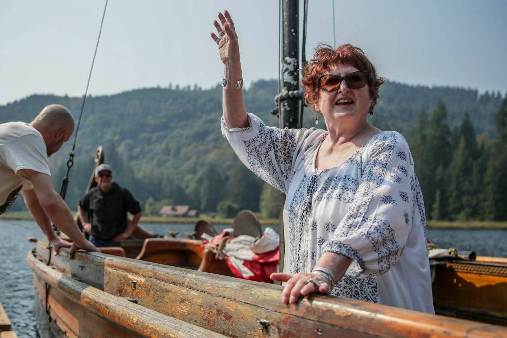 Mary Bettger, of Everett, waves aboard the ship built by her husband, Don, who died in 2011. She sold the Osa to the Sons of Norway for a $1. (Kevin Clark / The Herald)