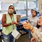 Tanya King, left, looks to where Hailey Newton, right, ask to hang her project on Sept. 14 at Beverly Elementary, in Lynnwood. (Kevin Clark / The Herald)