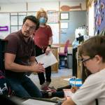 Zachary Pfrimmer gets together with a group of students to help them through an assignment in his fourth-grade classroom at Cedarhome Elementary on Sep. 21, in Stanwood. (Ryan Berry / The Herald)