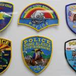 A portion of the law enforcement patch collections on display at Everett 911 Driving School, in Everett. (Kevin Clark / The Herald)